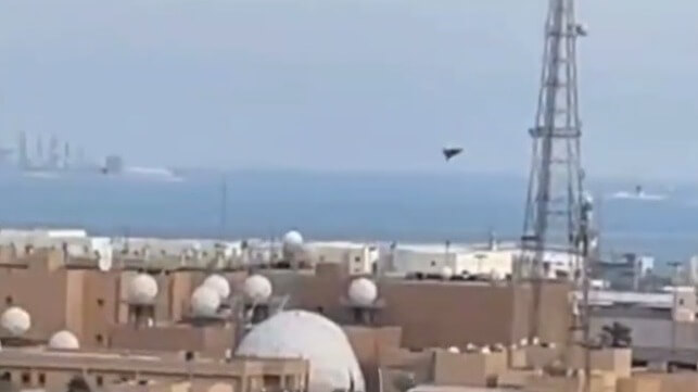 An Iranian Shahed-type drone dives on a large radome or satcom antenna at U.S. 5th Fleet's base in Manama (Bahraini social media)