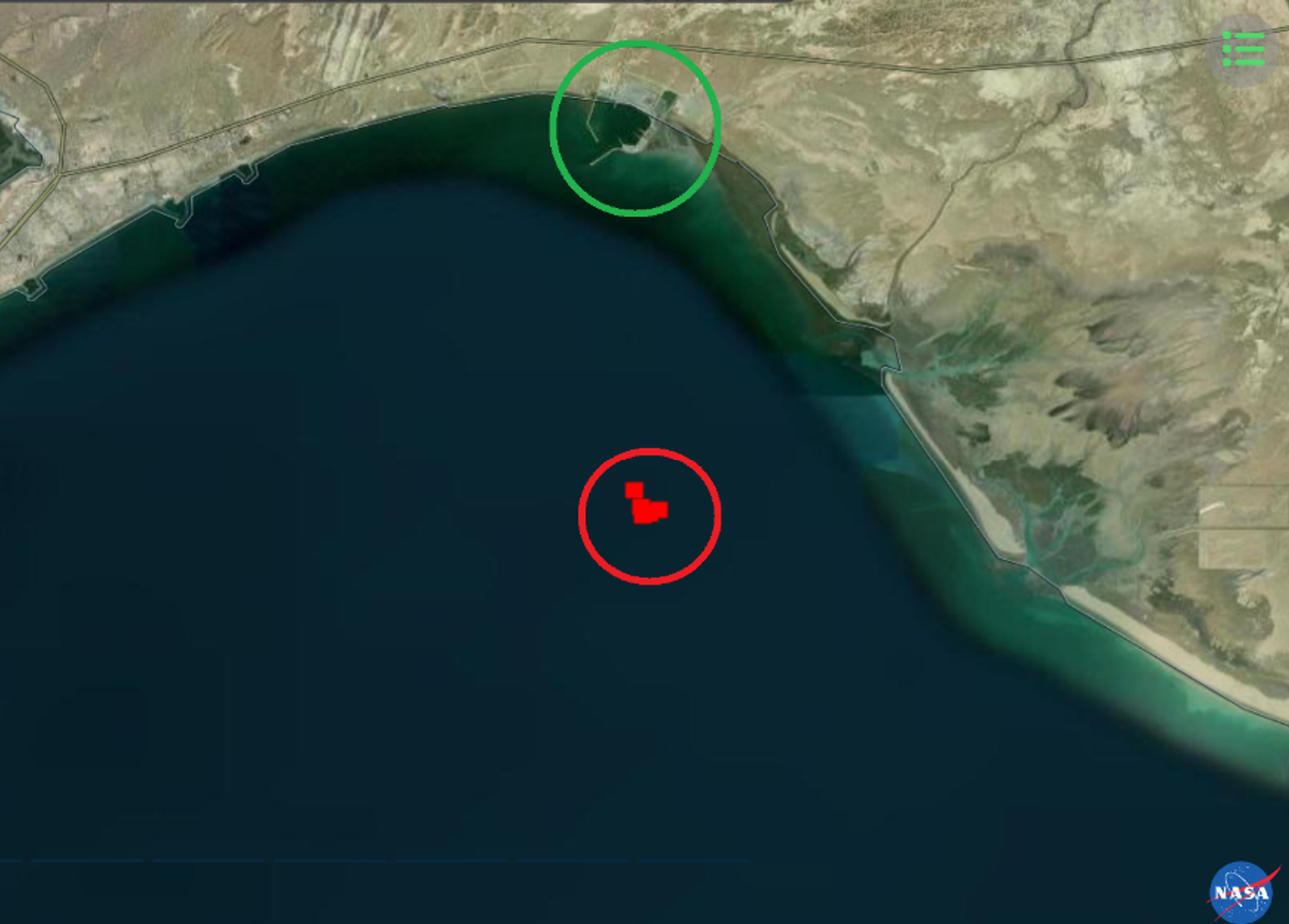 The heat spot being given off by the VLCC Sevda 11.5nm south-east of the Jask headland (circled in red), with the Jask naval base to the north circled in green (NASA FIRMS/CJRC)