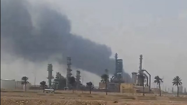 smoke rising from oil refinery 