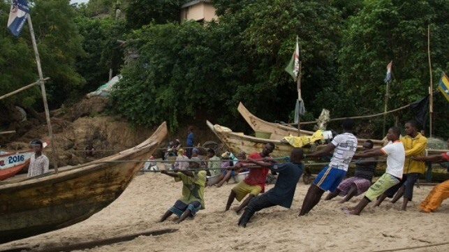 Ghanaian fishermen haul up their boats onto the beach (File image courtesy EJF)